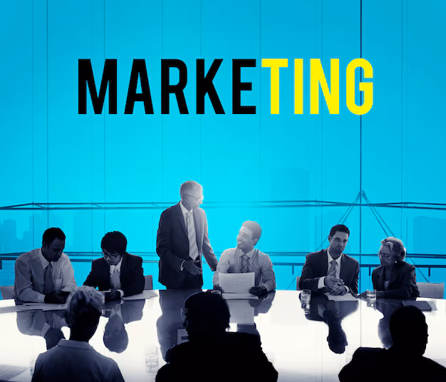 A big word "Marketing" showing in this picture and some people are sitting and a man standing and discussing each other on a topic of Digital marketing for real estate company